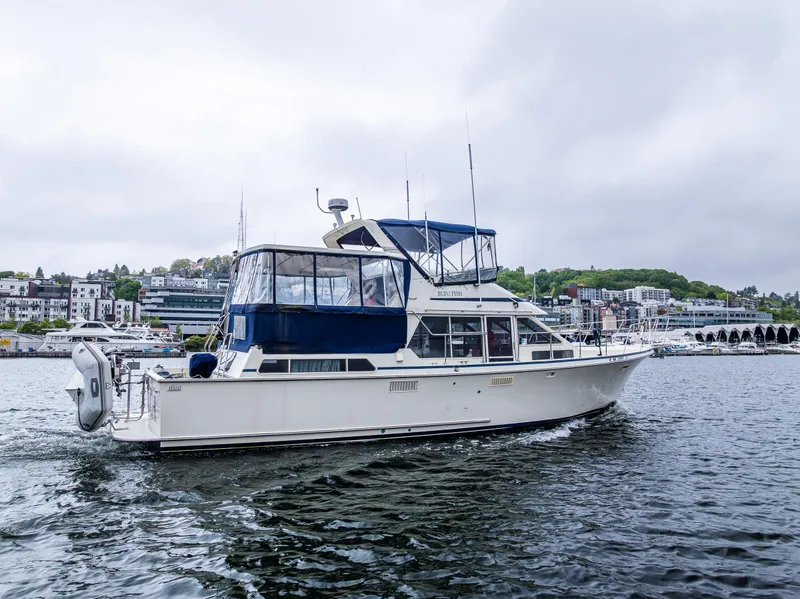Slide: The Image of 1988 Tollycraft 44 CPMY yacht cruising on a calm waterway. - 33