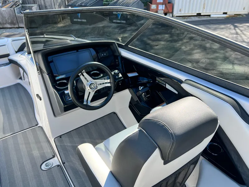 Slide: The Image of 2019 Yamaha Boats 242 Limited S cockpit with steering wheel and dashboard controls. - 6