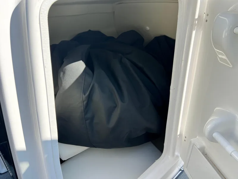 Slide: The Image of Storage compartment in a 2019 Yamaha Boats 242 Limited S, containing a black cover. - 9