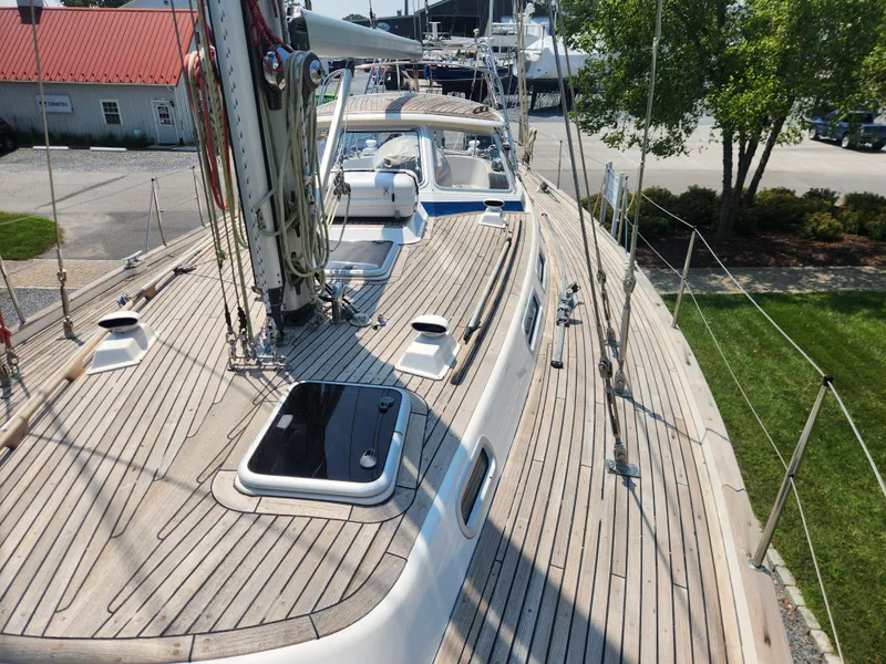 Slide: The Image of 2003 Hallberg-Rassy 46 sailboat deck with wooden finish and rigging details. - 10