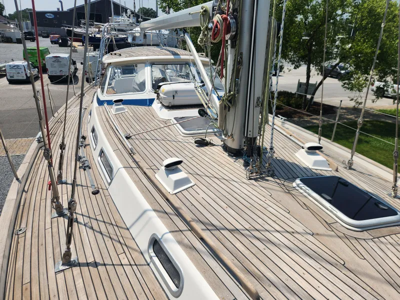 Slide: The Image of 2003 Hallberg-Rassy 46 sailboat deck with teak finish and rigging details. - 11