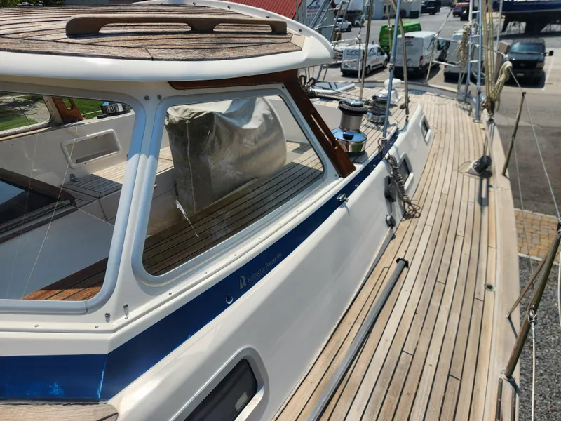 Slide: The Image of 2003 Hallberg-Rassy 46 yacht with teak deck and sleek cabin design. - 16