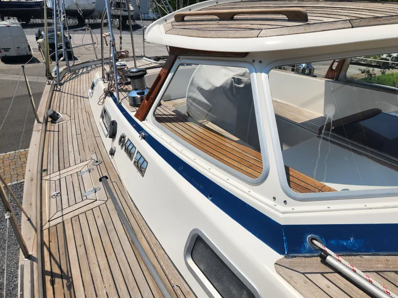 Slide: The Image of 2003 Hallberg-Rassy 46 yacht with teak deck and sleek cabin design. - 18