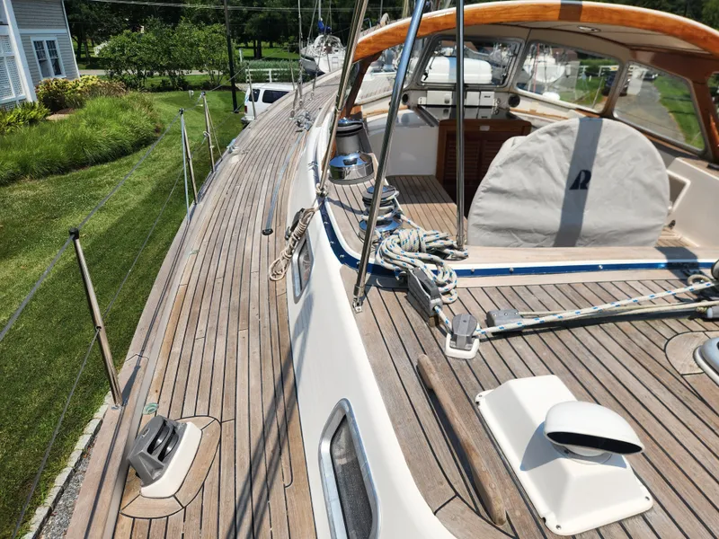 Slide: The Image of 2003 Hallberg-Rassy 46 sailboat deck with wooden finish and rigging details. - 19