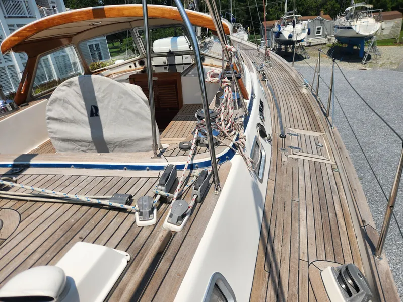 Slide: The Image of Deck view of a 2003 Hallberg-Rassy 46 sailboat with wooden details and rigging. - 20