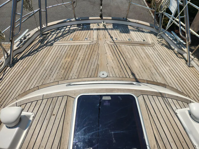 Slide: The Image of Deck of a 2003 Hallberg-Rassy 46 sailboat with teak wood finish. - 21