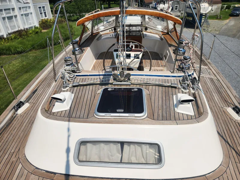 Slide: The Image of 2003 Hallberg-Rassy 46 sailboat deck with wooden finish and cockpit view. - 22