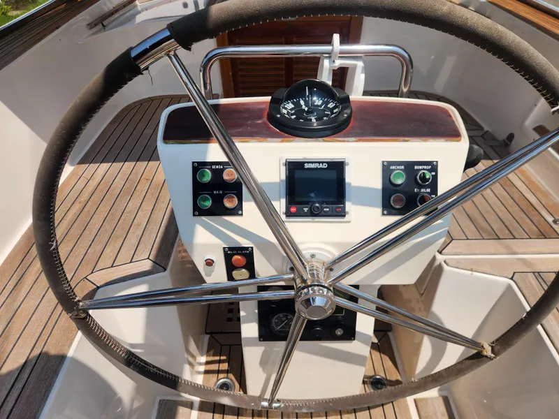 Slide: The Image of Steering wheel and controls of a 2003 Hallberg-Rassy 46 sailboat cockpit. - 23