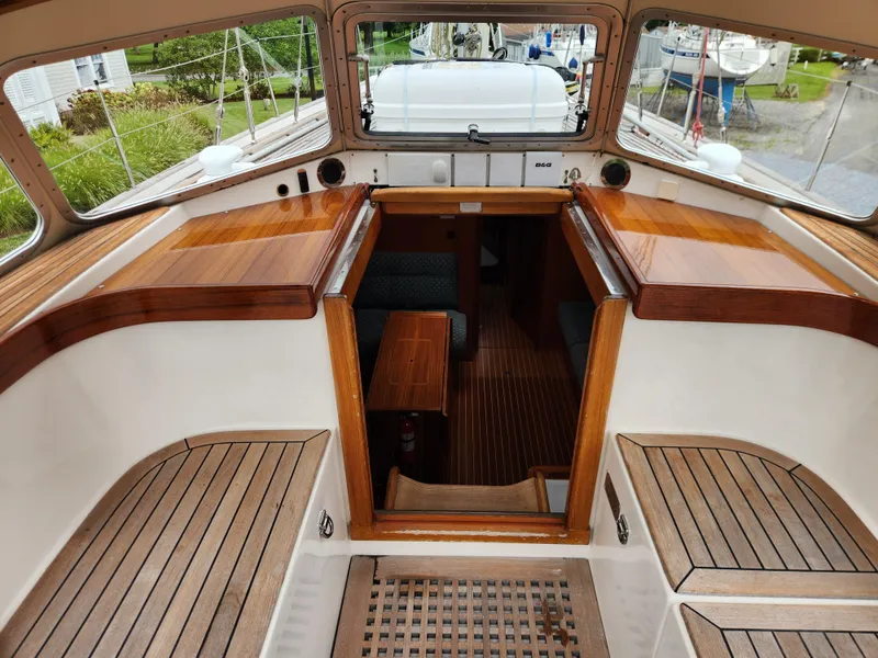 Slide: The Image of Cockpit view of 2003 Hallberg-Rassy 46 sailboat with wooden seating and cabin entrance. - 25