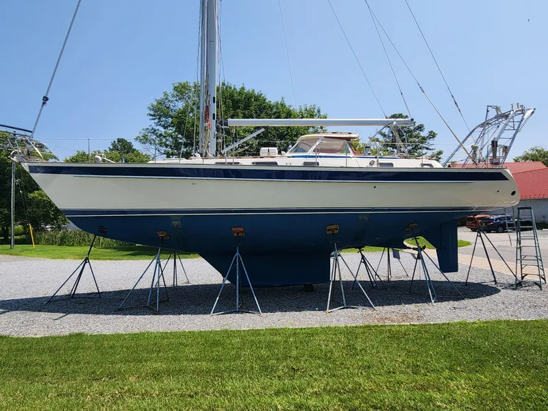 Slide: The Image of 2003 Hallberg-Rassy 46 sailboat on stands, displayed outdoors on a sunny day. - 3