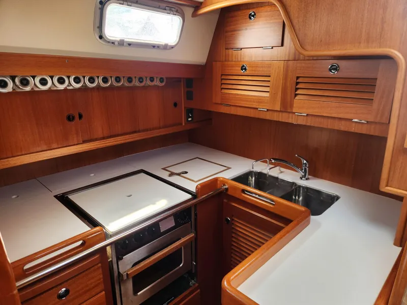 Slide: The Image of Luxurious 2003 Hallberg-Rassy 46 yacht kitchen with wood cabinetry and modern appliances. - 32