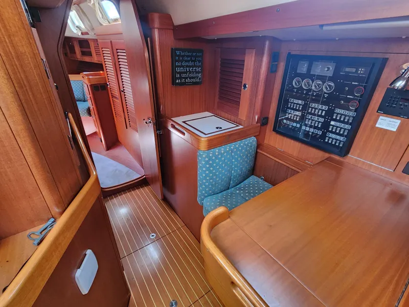 Slide: The Image of Interior of 2003 Hallberg-Rassy 46 yacht with wood paneling and control panel. - 33