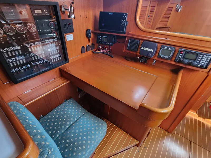 Slide: The Image of Navigation station of a 2003 Hallberg-Rassy 46 yacht with control panels and equipment. - 34