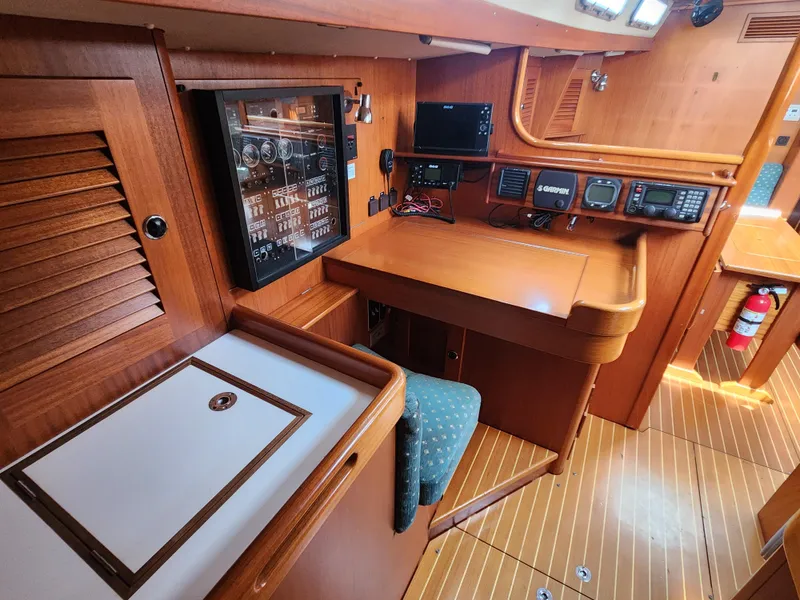Slide: The Image of Interior of 2003 Hallberg-Rassy 46 yacht with navigation equipment and wooden finish. - 36