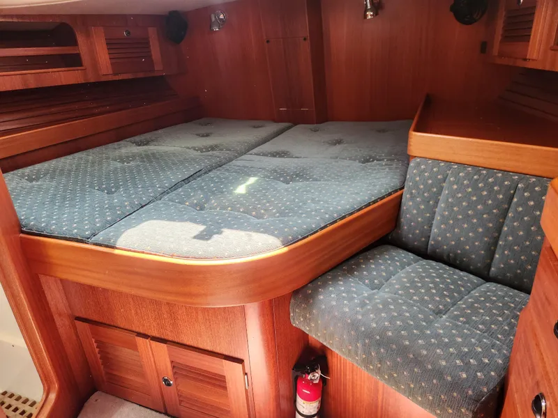 Slide: The Image of Cozy cabin interior of 2003 Hallberg-Rassy 46 yacht with wooden finish and blue upholstery. - 37