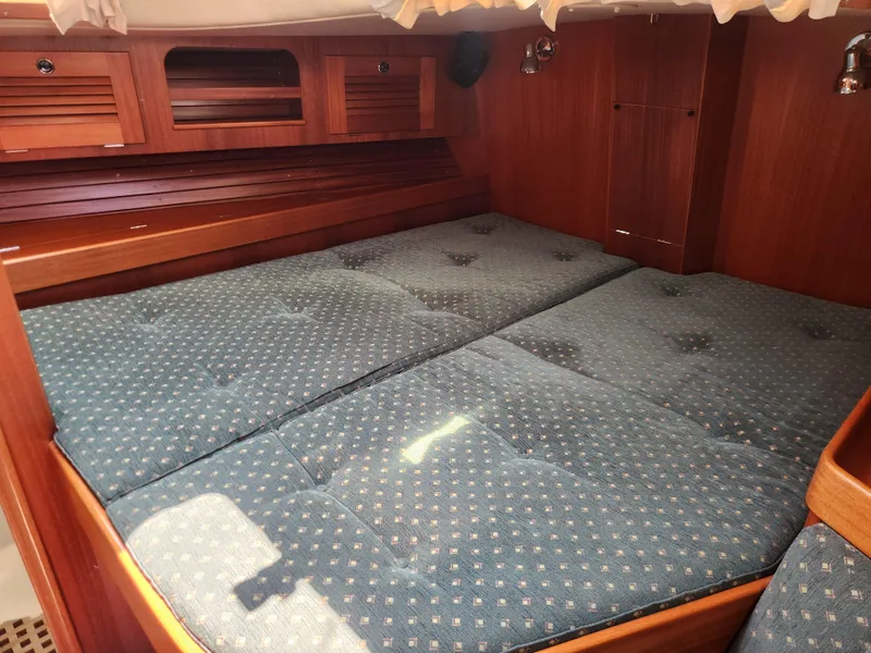 Slide: The Image of Cozy cabin interior of 2003 Hallberg-Rassy 46 yacht with blue patterned bedding. - 38