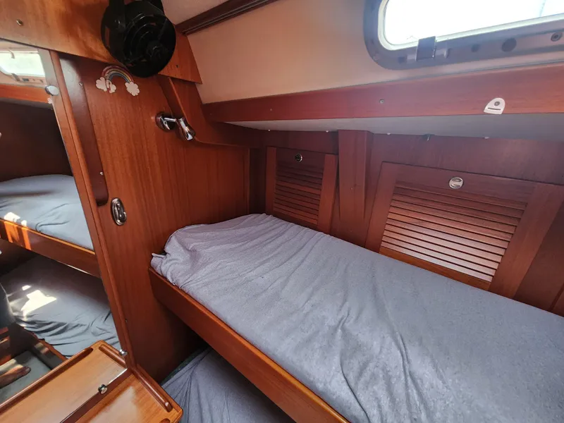 Slide: The Image of Cozy cabin interior of 2003 Hallberg-Rassy 46 sailboat with wooden finish and bunk beds. - 47