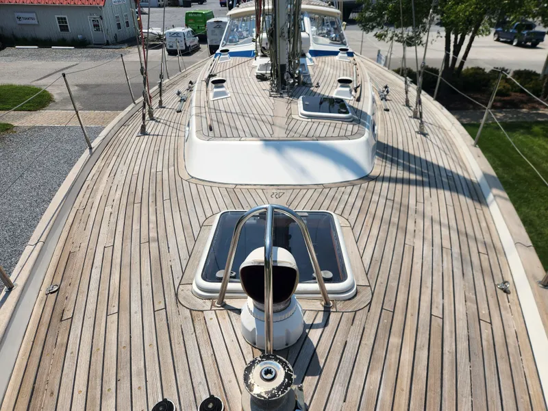 Slide: The Image of Deck of 2003 Hallberg-Rassy 46 sailboat with teak wood finish and hatch details. - 9