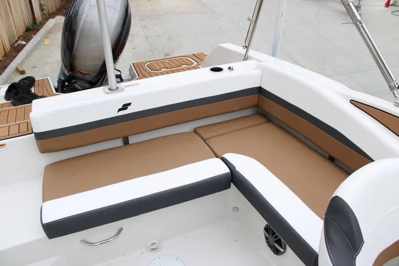 Slide: The Image of 2024 Starcraft SVX 210 OB DC boat interior with tan and white seating. - 10