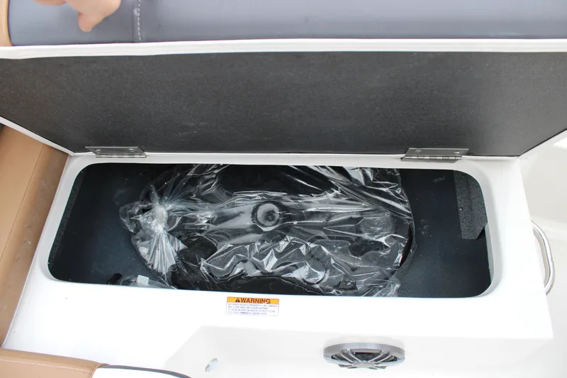 Slide: The Image of Storage compartment in 2024 Starcraft SVX 210 OB DC boat, featuring a covered interior space. - 11