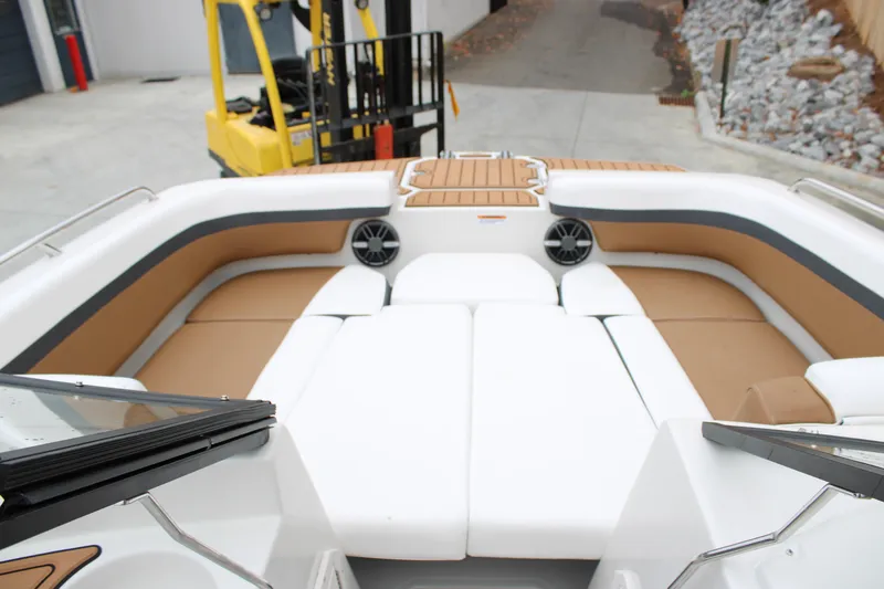 Slide: The Image of 2024 Starcraft SVX 210 OB DC boat interior with tan seating and speakers. - 5