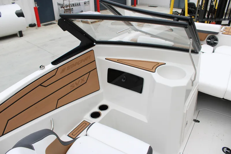 Slide: The Image of 2024 Starcraft SVX 210 OB DC boat interior with sleek design and cup holders. - 6