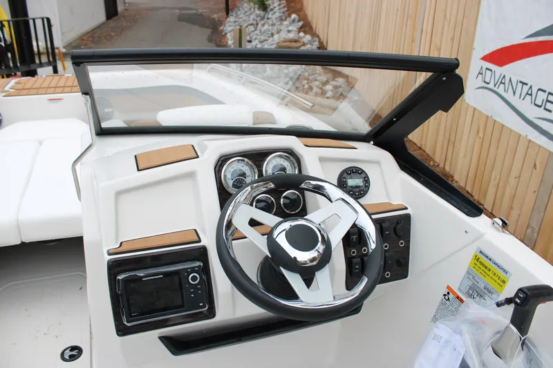 Slide: The Image of 2024 Starcraft SVX 210 OB DC boat dashboard with steering wheel and gauges. - 7