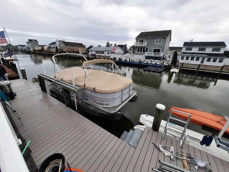 Slide: The Image of Pontoon boat Sylvan Mirage Cruise 8520 CR docked in a residential canal, 2015 model. - 3