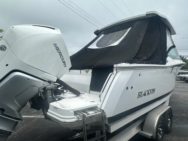 Slide: The Image of 2020 Blackfin 272 DC boat with Mercury engine on trailer, covered and ready for transport. - 1