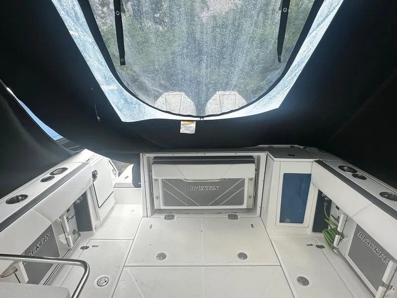 Slide: The Image of 2020 Blackfin 272 DC boat interior with covered seating and storage compartments. - 10