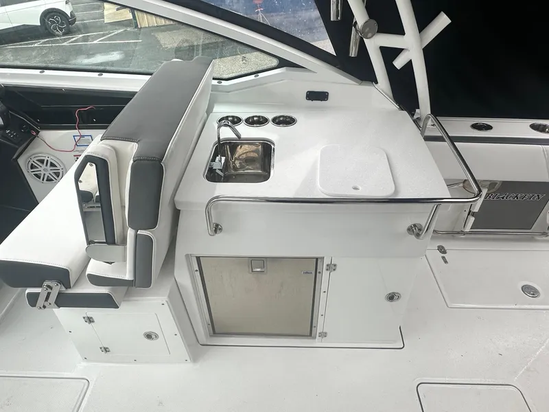 Slide: The Image of 2020 Blackfin 272 DC boat interior with sink and seating area. - 13