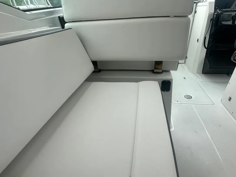 Slide: The Image of 2020 Blackfin 272 DC boat interior with white cushioned seating. - 19