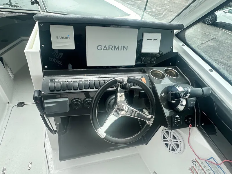 Slide: The Image of 2020 Blackfin 272 DC boat dashboard with Garmin navigation system and steering wheel. - 25