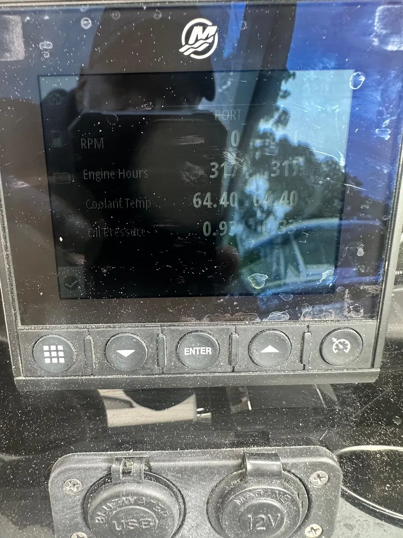 Slide: The Image of Close-up of a 2020 Blackfin 272 DC boat's digital display showing engine data. - 26