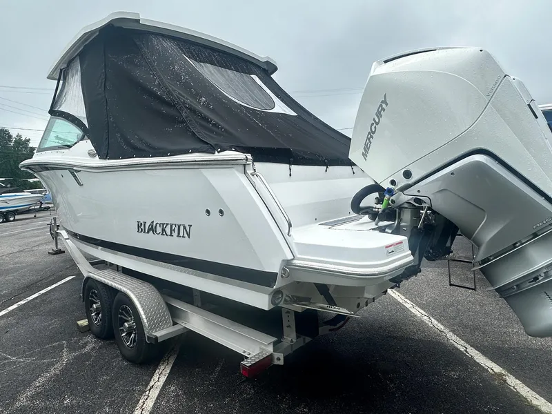 Slide: The Image of 2020 Blackfin 272 DC boat with Mercury engine on trailer, parked outdoors. - 3