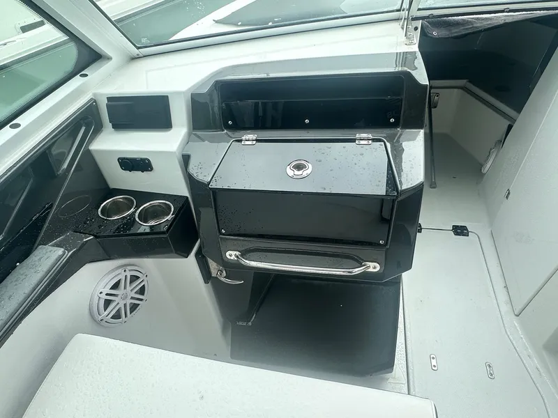 Slide: The Image of 2020 Blackfin 272 DC boat interior with storage, cup holders, and speaker. - 33