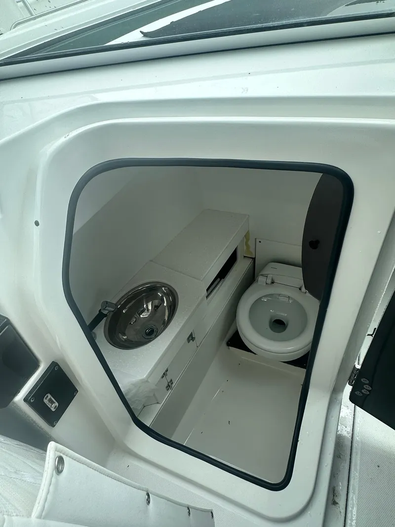 Slide: The Image of 2020 Blackfin 272 DC boat interior with compact bathroom and sink. - 34