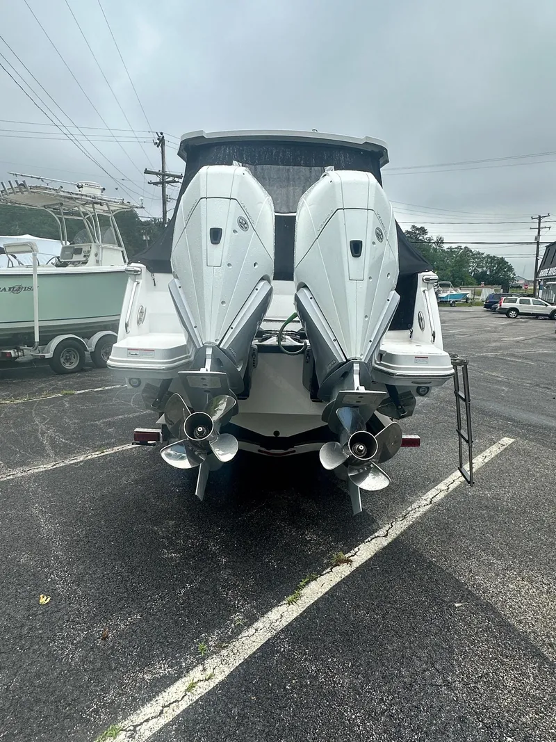 Slide: The Image of 2020 Blackfin 272 DC boat with dual outboard engines in a parking lot. - 5