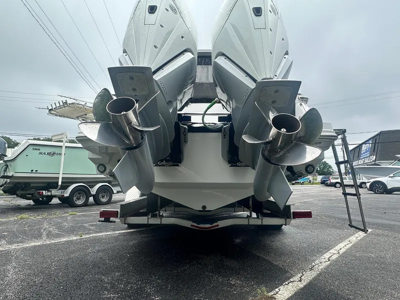 Slide: The Image of 2020 Blackfin 272 DC boat with dual outboard engines, parked on a trailer. - 6