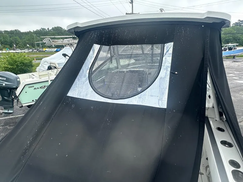 Slide: The Image of 2020 Blackfin 272 DC boat with black canvas cover and circular window. - 7