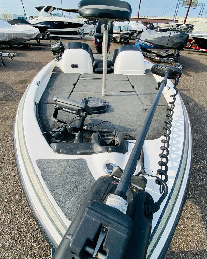 Slide: The Image of 2005 Skeeter SX190 boat with trolling motor, parked in a marina. - 3