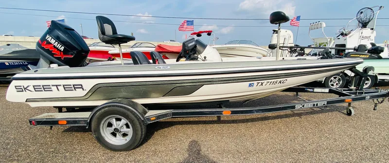 Slide: The Image of 2005 Skeeter SX190 boat on trailer with Yamaha outboard motor, parked outdoors. - 5
