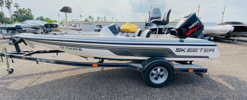 Slide: The Image of 2005 Skeeter SX190 boat on trailer with Yamaha outboard motor, parked outdoors. - 6