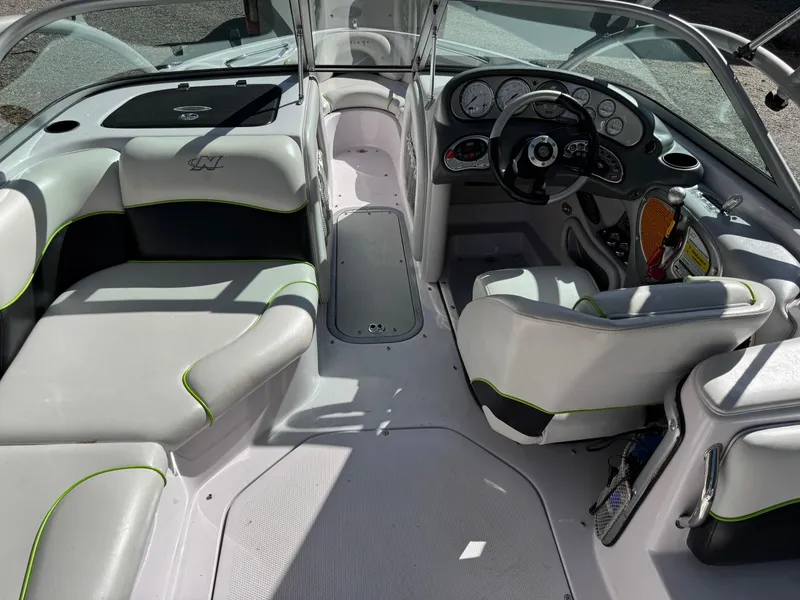 Slide: The Image of 2004 Correct Craft AIR NAUTIQUE SV 211 boat interior with seating and dashboard. - 4