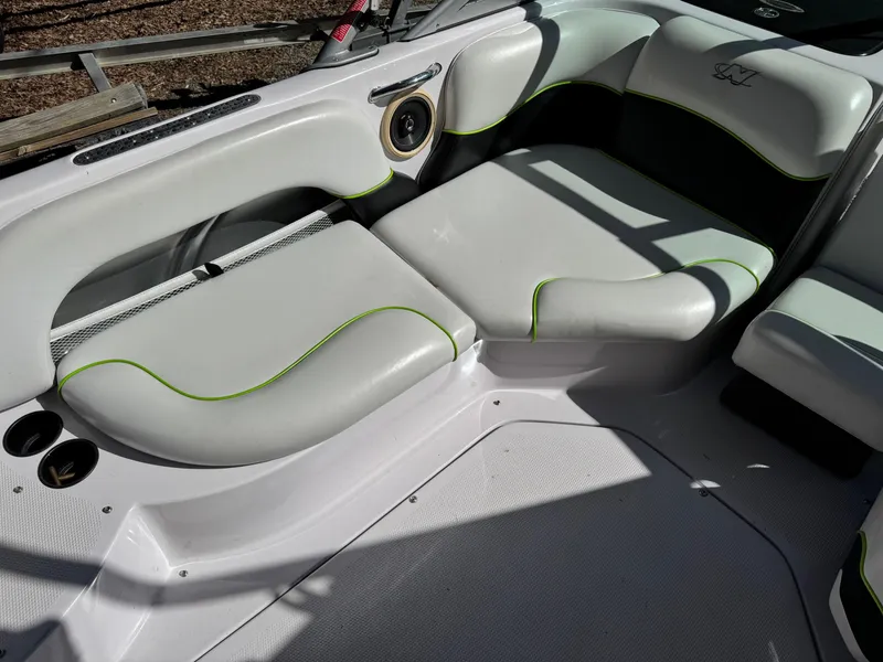 Slide: The Image of 2004 Correct Craft AIR NAUTIQUE SV 211 boat interior with gray seating and green accents. - 6