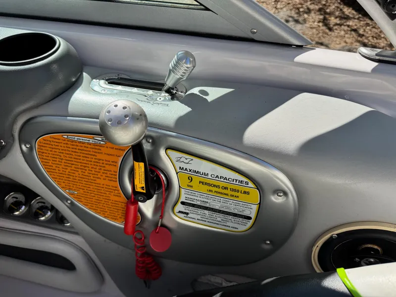 Slide: The Image of Dashboard of 2004 Correct Craft AIR NAUTIQUE SV 211 boat with capacity label. - 8