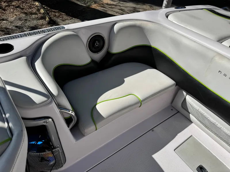 Slide: The Image of 2004 Correct Craft AIR NAUTIQUE SV 211 boat interior with gray and green seating. - 9