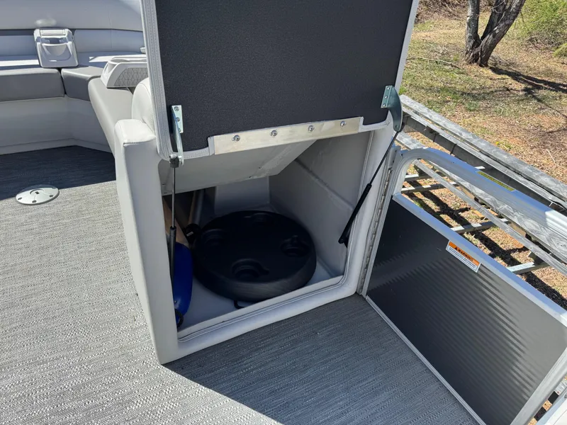 Slide: The Image of 2023 Godfrey Sweetwater 2086 C boat storage compartment with open hatch, revealing interior space. - 11