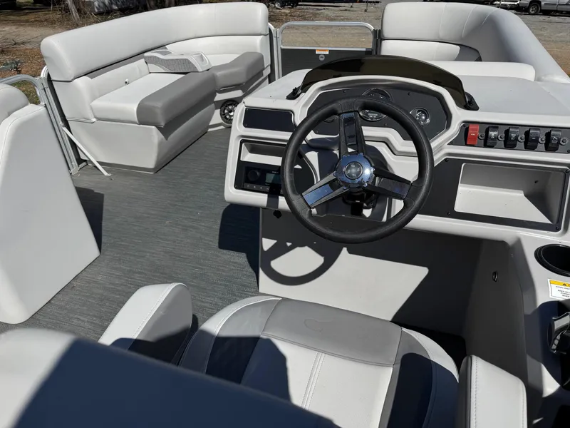 Slide: The Image of 2023 Godfrey Sweetwater 2086 C pontoon boat interior with steering wheel and seating. - 5