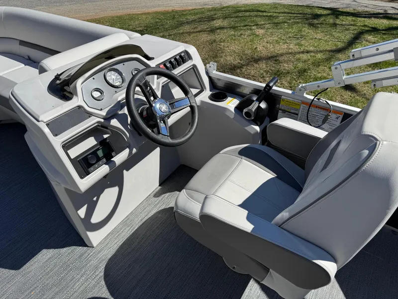 Slide: The Image of 2023 Godfrey Sweetwater 2086 C boat interior with steering wheel and seating. - 6